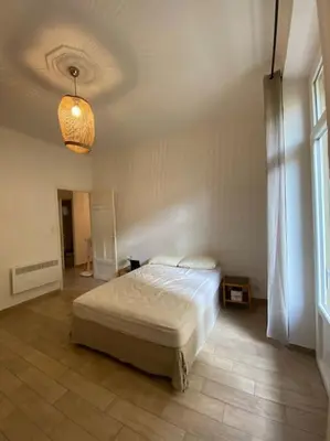 a bedroom with a bed and a light on the ceiling at appartement Cyrnos 3Pc 73m2 in Ajaccio