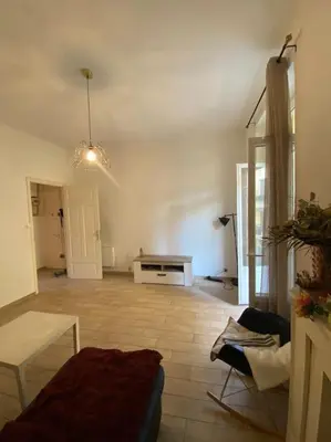 a living room with a couch and a table at appartement Cyrnos 3Pc 73m2 in Ajaccio