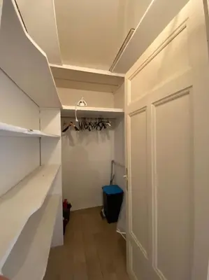 a room with a closet with a door and a shelf at appartement Cyrnos 3Pc 73m2 in Ajaccio