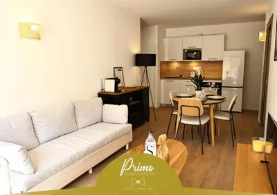a living room with a white couch and a table at U Paradisu - Magnifique T4, les pieds dans l'eau in Viagenti
