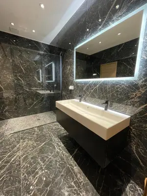 a bathroom with a sink and a mirror at appartement de standing avec jacuzzi exterieur in Zonza