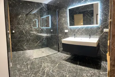 a bathroom with a sink and a mirror at appartement de standing avec jacuzzi exterieur in Zonza