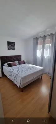 a bedroom with a large bed in a room at Cottage bergerie en pierres avec jacuzzi en corse 6 personnes, 3 chambres in Coti-Chiavari