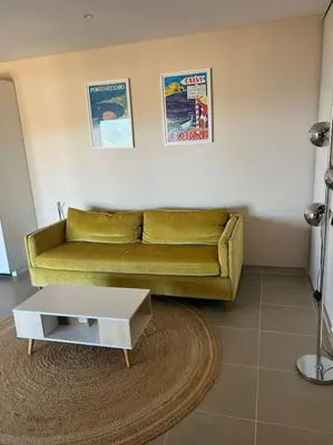 a living room with a couch and a coffee table at Rez de villa Favone in Conca