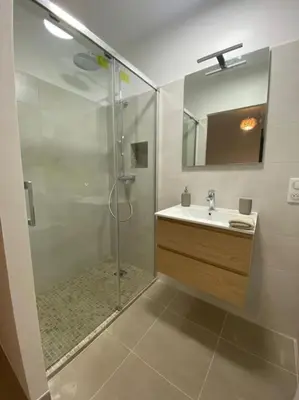 a bathroom with a shower and a sink at Rez de villa Favone in Conca