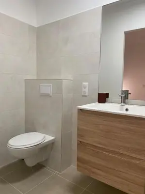 a bathroom with a toilet and a sink at Rez de villa Favone in Conca