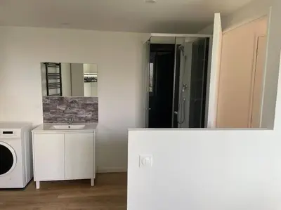 a white bathroom with a sink and a microwave at Appartement neuf dans hameau proche porto vecchio in Porto-Vecchio