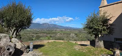 a view of a mountain range from a house at Appartement neuf dans hameau proche porto vecchio in Porto-Vecchio