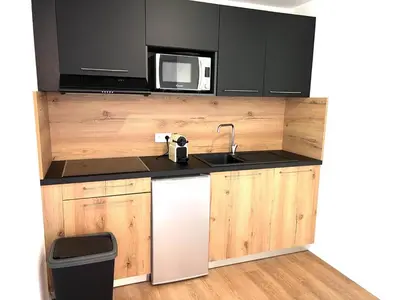 a kitchen with a sink and a microwave at Location T2 44 m2 proche plage Lecci appartement 82 in Lecci