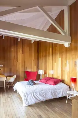 a bedroom with a large bed with red pillows at Villa Palombaggia in Porto-Vecchio