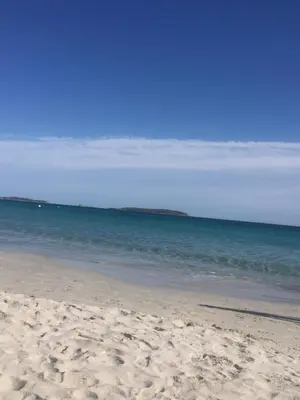a sandy beach with the ocean in the background at Villa Palombaggia in Porto-Vecchio