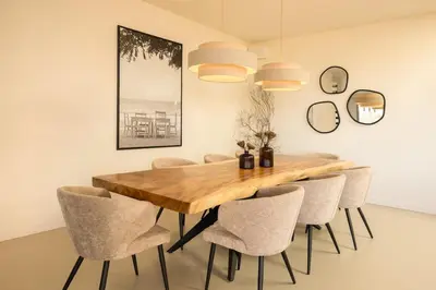 a dining room with a wooden table and chairs at Villa Yaya in Cervione