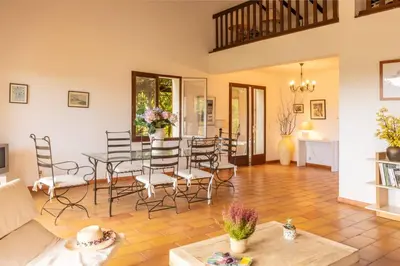 a living room with a table and chairs at Villa Josiane in San-Nicolao