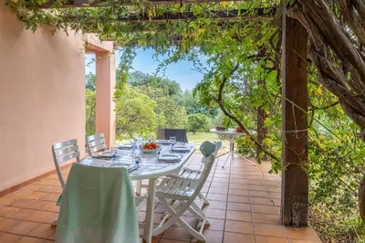 a table and chairs sitting on a patio at Villa Josiane in San-Nicolao