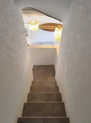 a hallway with a staircase with two lights and a stair case at Villa Cosy, 75m2, climatisé, 200m plage, parking in Lecci