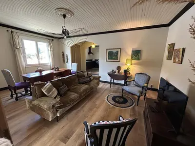 a living room with a couch and a table at Appartement de charme vue mer in Kamiesch