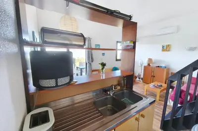 a kitchen with a sink and a tv in a room at Nice quiet accommodation in Grosseto-Prugna in Grosseto-Prugna