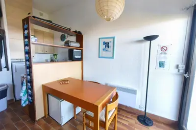 a dining room with a table and a refrigerator at Nice quiet accommodation in Grosseto-Prugna in Grosseto-Prugna