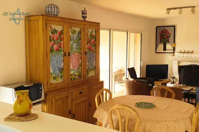 a kitchen with a china cabinet with flowers on it at A Casa Apa Vue mer Plage a pied Ruppione Pietrosella in Pietrosella