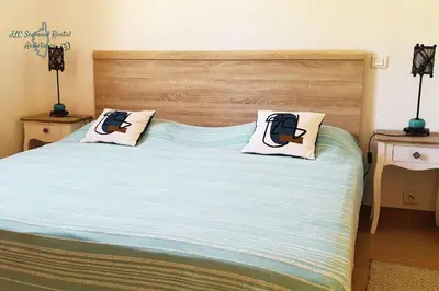 a bedroom with a bed with two pillows on it at A Casa Apa Vue mer Plage a pied Ruppione Pietrosella in Pietrosella