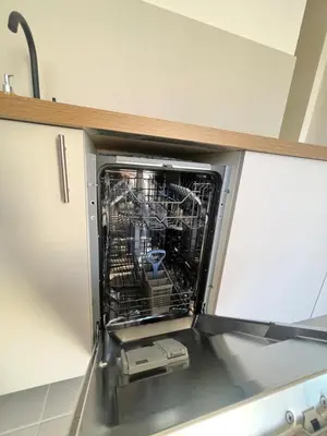 a dishwasher with its door open in a kitchen at LE FINOSELLO - T2 Cosy sur Ajaccio avec Clim, Wifi & Parking - proche Port & Aéroport in Ajaccio
