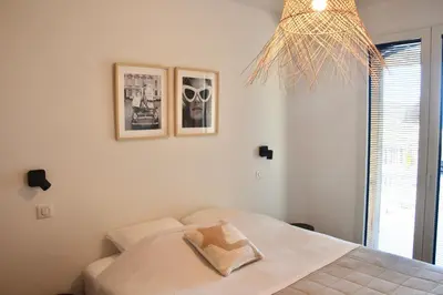 a bedroom with a bed with a towel on it at Maison Bord'eau in Sainte-Lucie de Porto-Vecchio