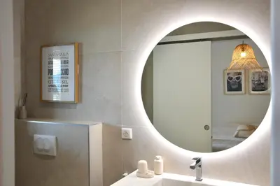 a bathroom with a mirror and a sink at Maison Bord'eau in Sainte-Lucie de Porto-Vecchio