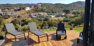 three chairs sitting on top of a wooden deck at Duplex neuf T3 terrasse et jardin proche plages in Pietrosella