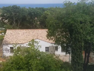 an aerial view of a white house with trees at Villa neuve à 900 m de la plage in Santa-Lucia-di-Moriani