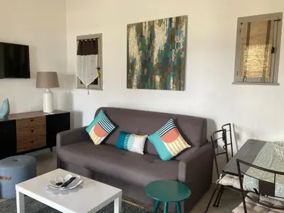 a living room with a couch and a table at Villa vue mer exceptionnelle à 500m de la plage de Santa Giulia in Porto-Vecchio