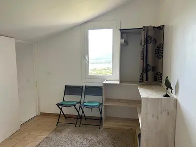 a room with two chairs and a desk and a window at Villa vue mer exceptionnelle à 500m de la plage de Santa Giulia in Porto-Vecchio
