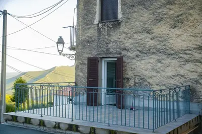a balcony of a building with a gate and a window at Location F2 44 m2 in Venaco