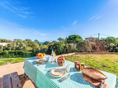 a picnic table with a cat sitting on top of it at Apartment T1 Gabriello by Interhome in Cala dʼOro