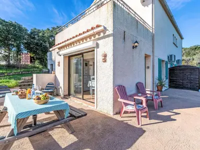 a patio with a table and chairs on a patio at Apartment T1 Gabriello by Interhome in Cala dʼOro
