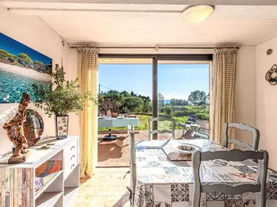 a dining room with a table and a large window at Apartment T1 Gabriello by Interhome in Cala dʼOro