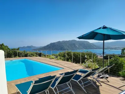 a villa with a swimming pool and an umbrella at Villa Villa Sallena by Interhome in Porto-Vecchio