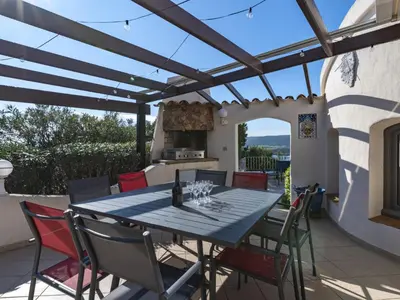 a patio with a table and chairs and a kitchen at Villa Villa Sallena by Interhome in Porto-Vecchio