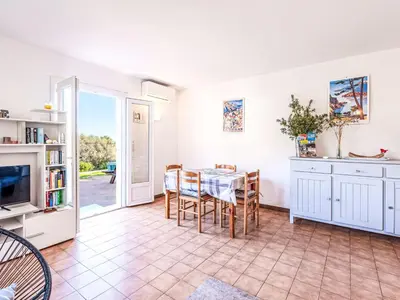 a kitchen and dining room with a table and chairs at Apartment T2 Gabriello by Interhome in Cala dʼOro
