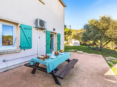 a table with a blue table cloth sitting on a patio at Apartment T2 Gabriello by Interhome in Cala dʼOro
