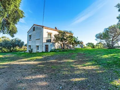 an old house on a grassy field with trees at Apartment T2 Gabriello by Interhome in Cala dʼOro