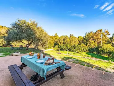 a picnic table with a blue table cloth on it at Apartment T2 Gabriello by Interhome in Cala dʼOro