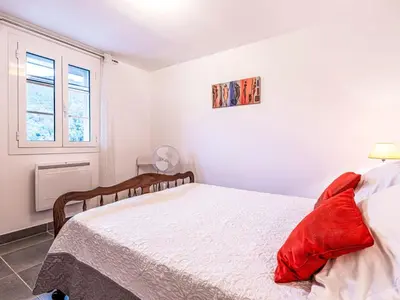 a white bedroom with a bed and a window at Holiday Home Casa Santa Reparata by Interhome in Santa-Reparata-di-Moriani
