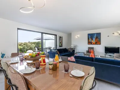 a living room with a table and a couch at Villa Villa Lamas by Interhome in Sainte-Lucie de Porto-Vecchio