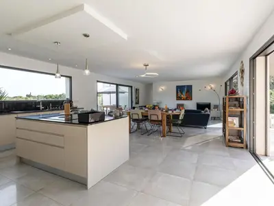 an open kitchen and living room with a dining room at Villa Villa Lamas by Interhome in Sainte-Lucie de Porto-Vecchio