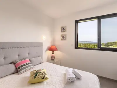 a bedroom with a large bed with a window at Villa Villa Lamas by Interhome in Sainte-Lucie de Porto-Vecchio