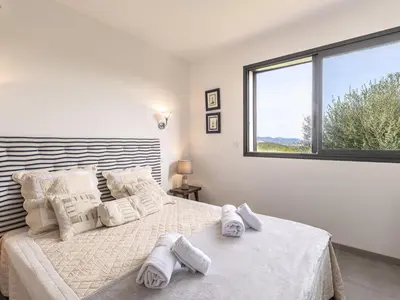 a bedroom with a large bed with towels on it at Villa Villa Lamas by Interhome in Sainte-Lucie de Porto-Vecchio