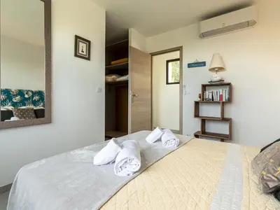 a bedroom with a bed with towels on it at Villa Villa Lamas by Interhome in Sainte-Lucie de Porto-Vecchio