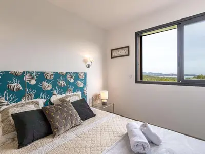a bedroom with a bed and a large window at Villa Villa Lamas by Interhome in Sainte-Lucie de Porto-Vecchio
