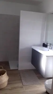 a white bathroom with a sink and a toilet at Villa spacieuse à Zonza avec piscine privée in Conca
