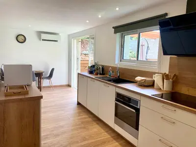 a kitchen with white cabinets and a counter top at Casa Chiaverini in Lecci